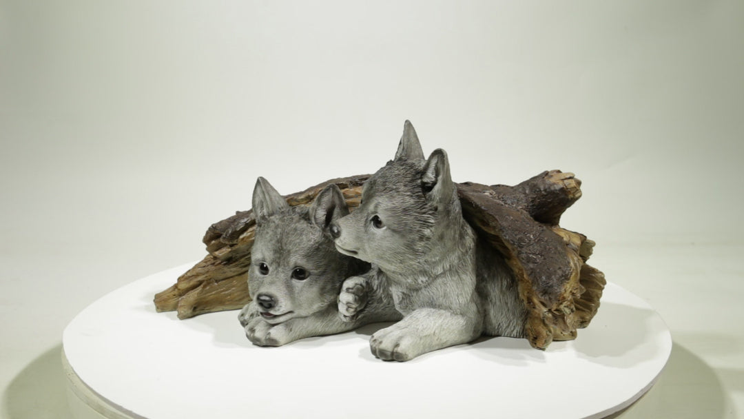Gray Wolf Cubs Hiding under Log Statue